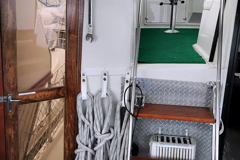 Slide: The Image of 1991 Californian 52 Cockpit Motor Yacht interior with wooden steps and nautical ropes. - 11