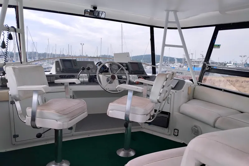 Slide: The Image of Cockpit of 1991 Californian 52 Motor Yacht with steering wheel and navigation equipment. - 12
