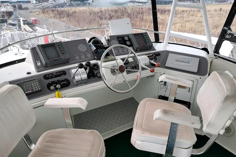 Slide: The Image of Cockpit of 1991 Californian 52 Cockpit Motor Yacht with navigation equipment and seating. - 13
