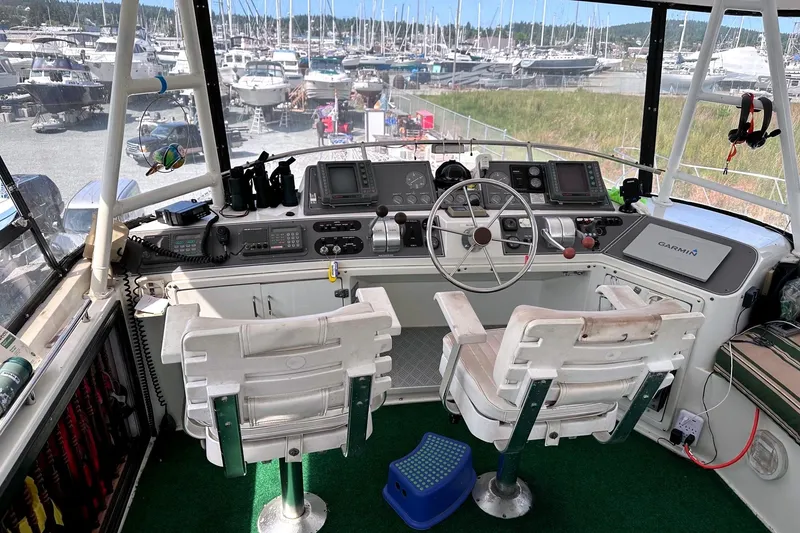 Slide: The Image of Cockpit of 1991 Californian 52 Cockpit Motor Yacht with steering wheel and navigation equipment. - 14
