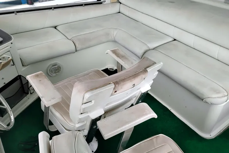 Slide: The Image of 1991 Californian 52 Cockpit Motor Yacht interior with white seating and green carpet. - 15