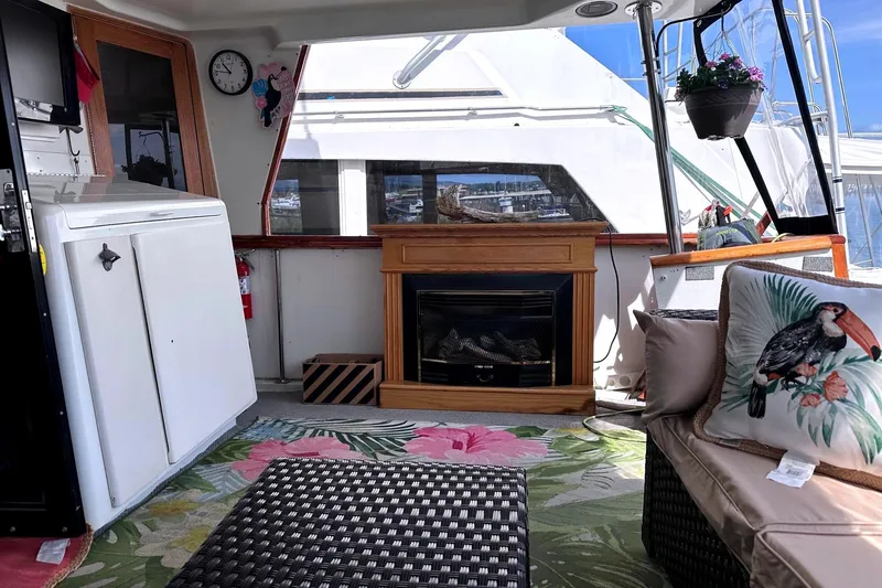 Slide: The Image of Interior of 1991 Californian 52 Cockpit Motor Yacht with cozy seating and fireplace. - 17