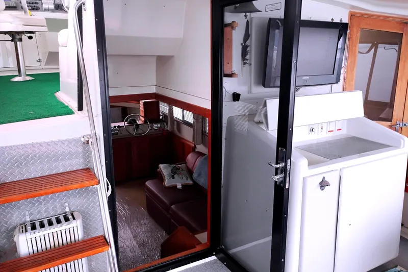 Slide: The Image of Interior of 1991 Californian 52 Cockpit Motor Yacht with seating and control area. - 18