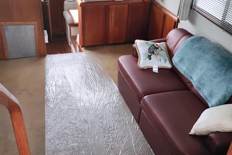 Slide: The Image of Interior of 1991 Californian 52 Cockpit Motor Yacht with leather sofa and decorative pillows. - 21