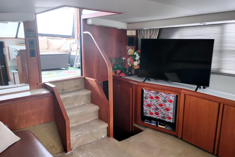Slide: The Image of Interior of 1991 Californian 52 Cockpit Motor Yacht with TV and stairs. - 22