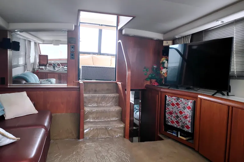 Slide: The Image of Interior of 1991 Californian 52 Cockpit Motor Yacht with TV and seating area. - 23