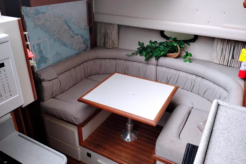 Slide: The Image of Interior of 1991 Californian 52 Cockpit Motor Yacht with cozy dining area and map decor. - 27