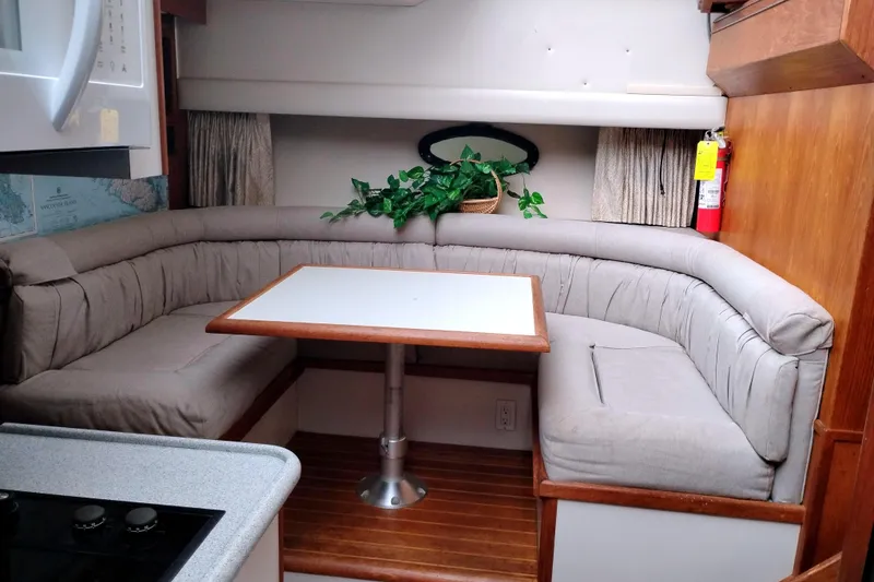 Slide: The Image of 1991 Californian 52 Cockpit Motor Yacht interior with cozy dining area and plush seating. - 28