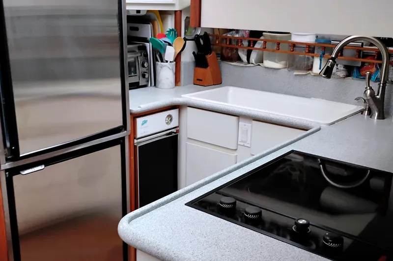 Slide: The Image of Kitchen area of a 1991 Californian 52 Cockpit Motor Yacht with modern appliances. - 29