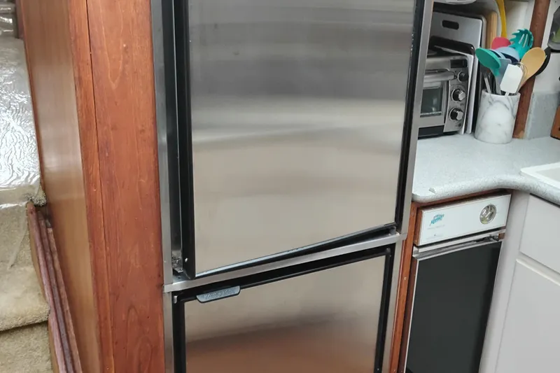 Slide: The Image of Kitchen area of a 1991 Californian 52 Cockpit Motor Yacht with stainless steel appliances. - 33