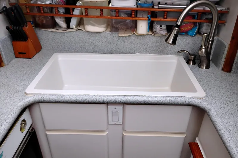 Slide: The Image of Kitchen sink area in a 1991 Californian 52 Cockpit Motor Yacht, featuring modern faucet. - 34