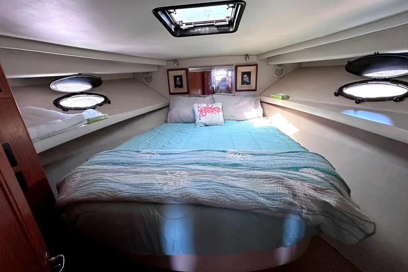 Slide: The Image of Cozy bedroom in 1991 Californian 52 Cockpit Motor Yacht with skylight and portholes. - 36