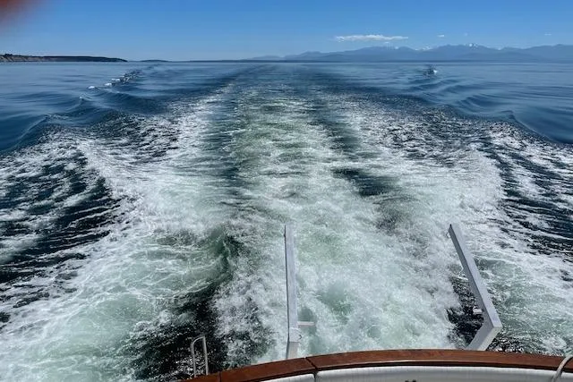 Slide: The Image of Wake of 1991 Californian 52 Cockpit Motor Yacht cruising on open water. - 4