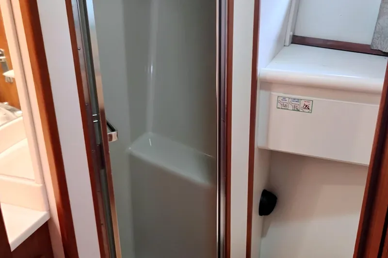 Slide: The Image of Shower area inside 1991 Californian 52 Cockpit Motor Yacht, featuring sleek design and compact space. - 40