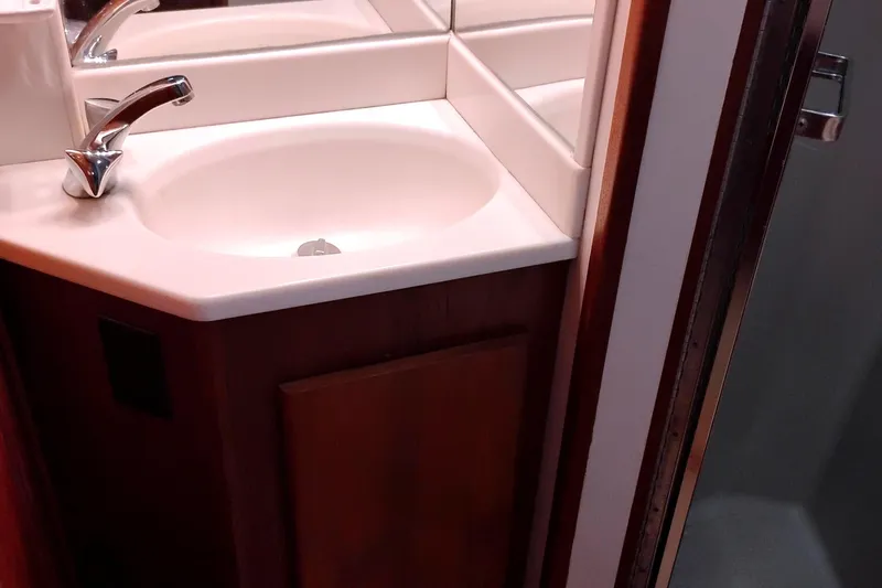 Slide: The Image of Bathroom sink area in 1991 Californian 52 Cockpit Motor Yacht, featuring a modern faucet. - 41