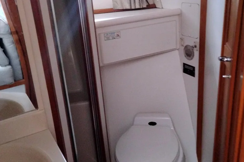 Slide: The Image of Bathroom interior of 1991 Californian 52 Cockpit Motor Yacht, featuring toilet and shower. - 42