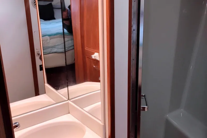 Slide: The Image of Bathroom interior of 1991 Californian 52 Cockpit Motor Yacht with mirrored cabinet. - 43