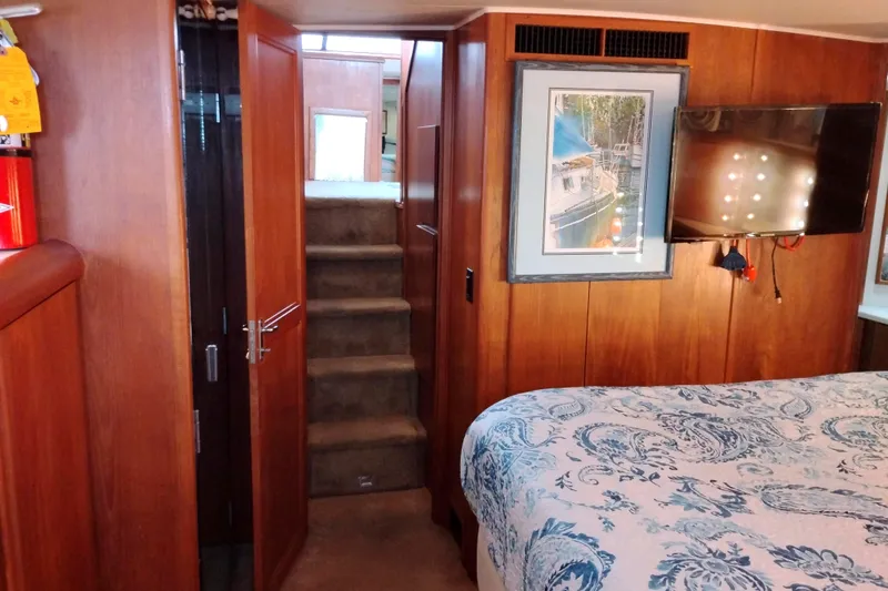 Slide: The Image of Interior of 1991 Californian 52 Cockpit Motor Yacht with wood paneling and cozy bedroom. - 45