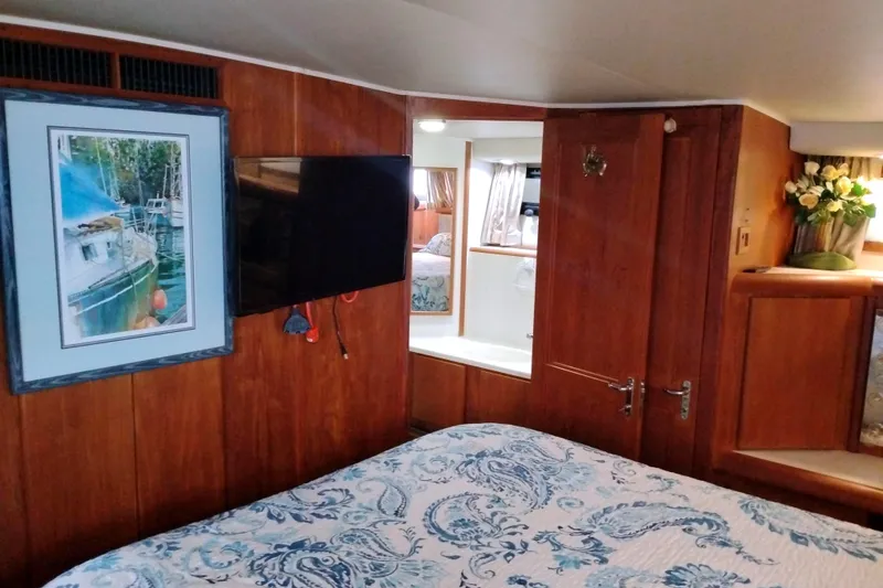 Slide: The Image of Interior of 1991 Californian 52 Cockpit Motor Yacht with wood paneling and floral decor. - 46