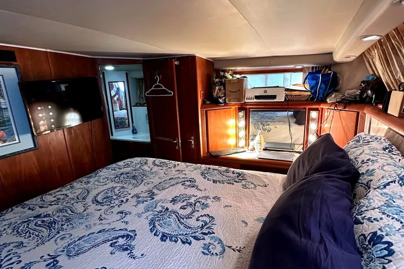 Slide: The Image of Cozy bedroom in 1991 Californian 52 Cockpit Motor Yacht with elegant decor and ample lighting. - 48