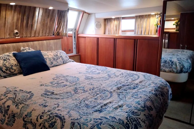 Slide: The Image of Luxurious bedroom interior of 1991 Californian 52 Cockpit Motor Yacht with elegant bedding. - 49