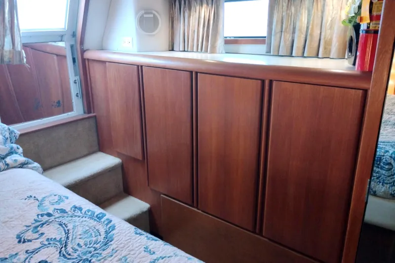 Slide: The Image of Interior of 1991 Californian 52 Cockpit Motor Yacht with wooden cabinetry and carpeted steps. - 52