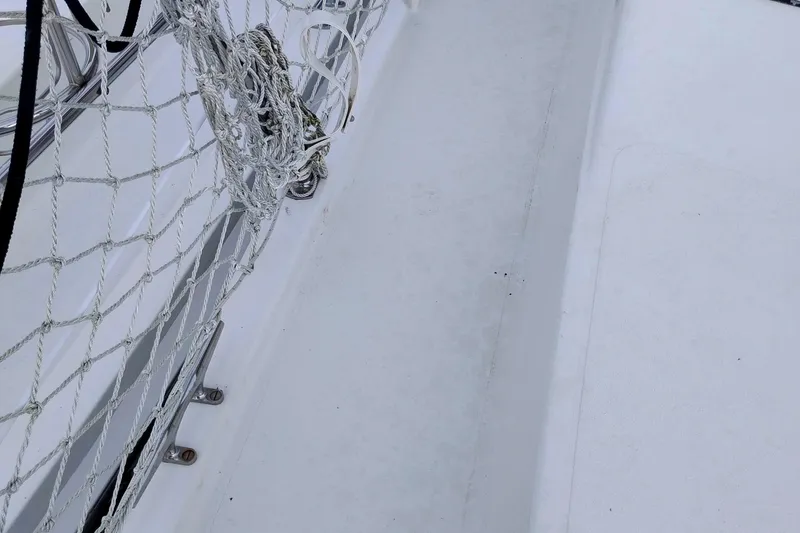 Slide: The Image of Deck of 1991 Californian 52 Cockpit Motor Yacht with safety netting and ropes. - 56