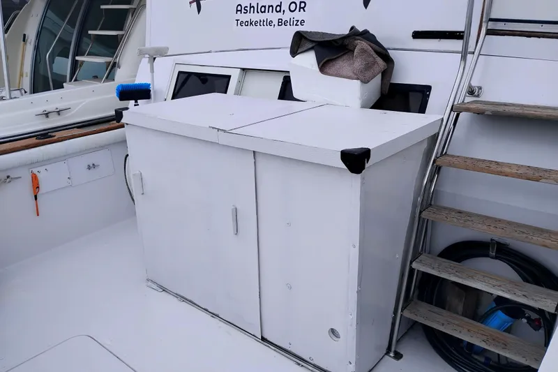 Slide: The Image of 1991 Californian 52 Cockpit Motor Yacht deck with storage cabinet and stairs. - 6