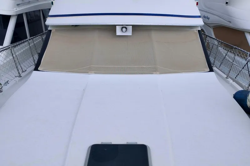 Slide: The Image of 1991 Californian 52 Cockpit Motor Yacht with covered windshield and deck view. - 60