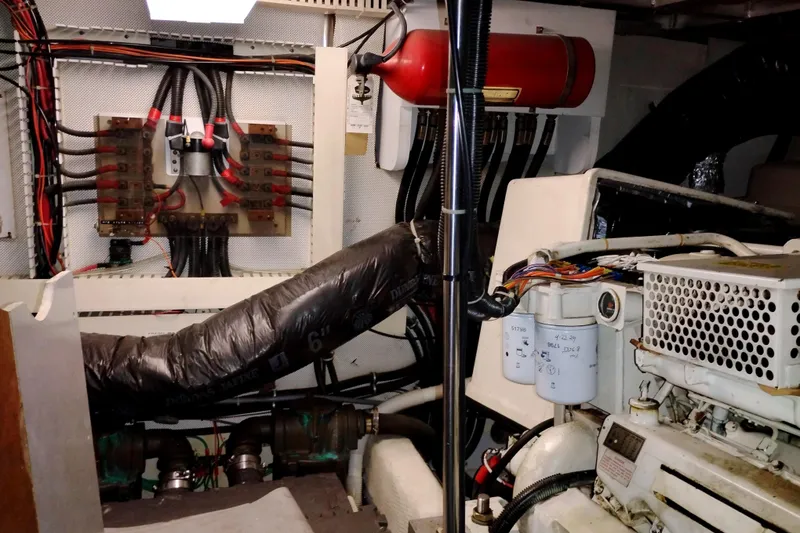 Slide: The Image of Engine room of a 1991 Californian 52 Cockpit Motor Yacht with wiring and machinery. - 63