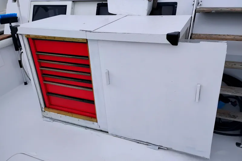 Slide: The Image of Red tool chest and white storage cabinet on 1991 Californian 52 Cockpit Motor Yacht. - 7