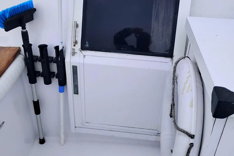 Slide: The Image of 1991 Californian 52 Cockpit Motor Yacht deck with cleaning tools and life preserver. - 8