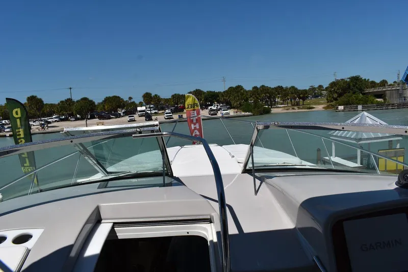 Slide: The Image of 2005 Formula 37 PC yacht docked at a marina with clear blue skies. - 21