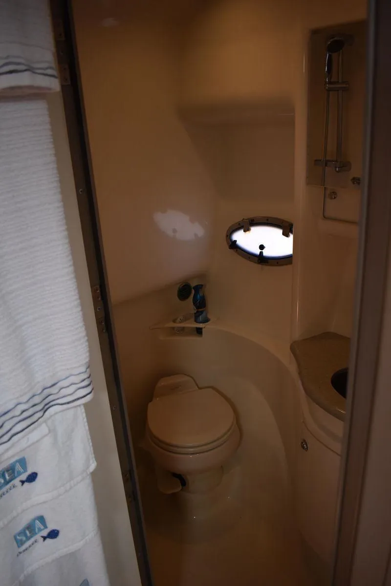 Slide: The Image of 2005 Formula 37 PC yacht bathroom with toilet and porthole window. - 32