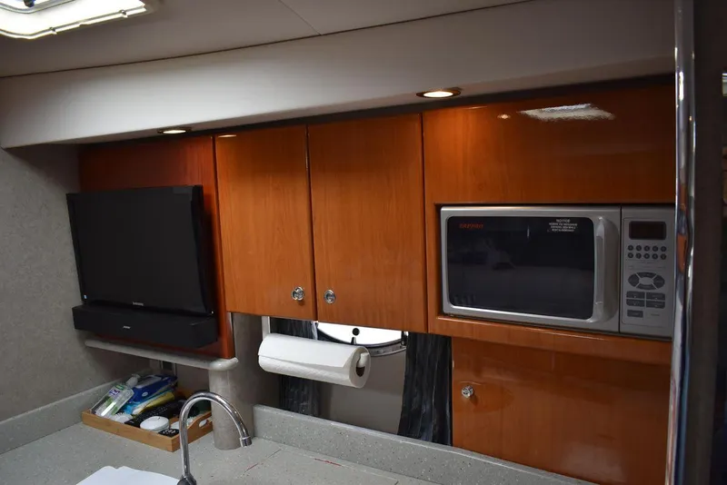 Slide: The Image of 2005 Formula 37 PC yacht kitchen with microwave, TV, and wooden cabinets. - 36