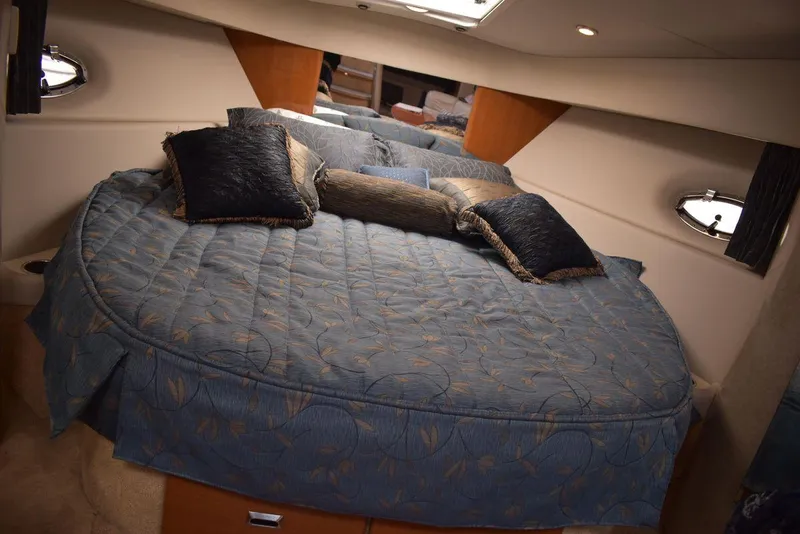 Slide: The Image of Luxurious bedroom in a 2005 Formula 37 PC yacht with plush bedding and pillows. - 42
