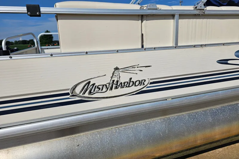 Slide: The Image of 2004 Misty Harbor 2285CF pontoon boat with logo and railing detail. - 4
