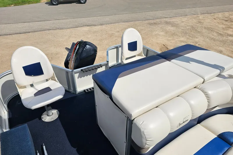 Slide: The Image of 2004 Misty Harbor 2285CF boat interior with seating and Mercury outboard motor. - 6