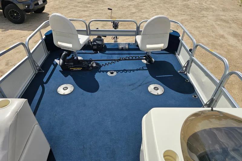 Slide: The Image of 2004 Misty Harbor 2285CF pontoon boat interior with blue carpet and white seats. - 7