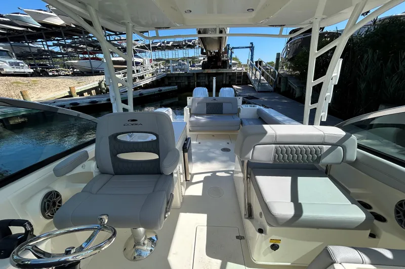 Slide: The Image of 2026 Cobia 280 Dual Console boat interior with luxurious seating and modern design. - 13