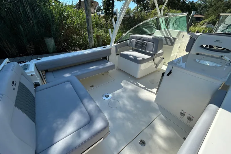 Slide: The Image of 2026 Cobia 280 Dual Console boat interior with spacious seating and modern design. - 6