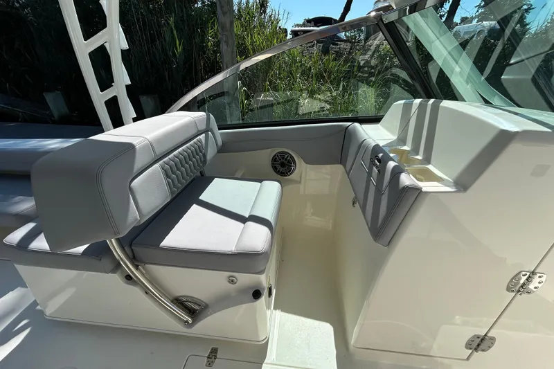 Slide: The Image of 2026 Cobia 280 Dual Console interior with cushioned seating and sleek design. - 9