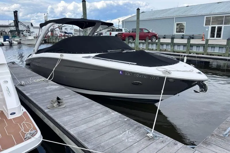 Slide: The Image of 2015 Regal 2800 Bowrider boat docked at marina, covered and secured. - 0