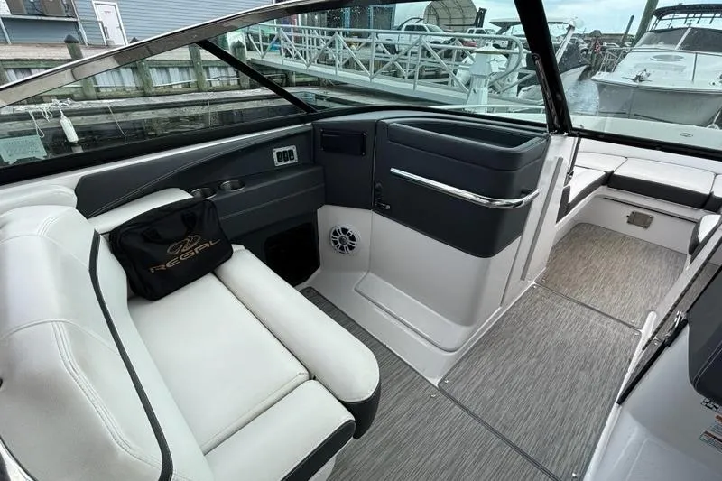 Slide: The Image of 2015 Regal 2800 Bowrider interior with white seating and modern dashboard. - 10