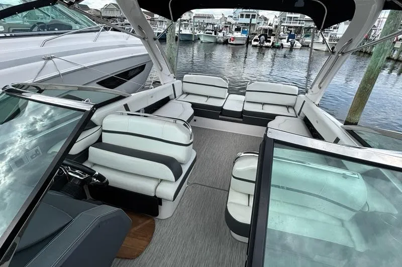 Slide: The Image of 2015 Regal 2800 Bowrider interior with spacious seating, docked at marina. - 15