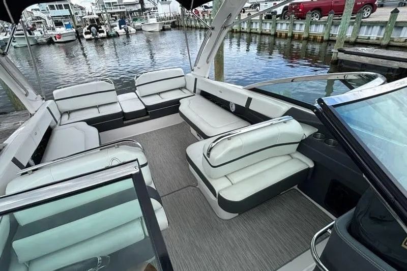 Slide: The Image of 2015 Regal 2800 Bowrider with spacious seating at a marina dock. - 16