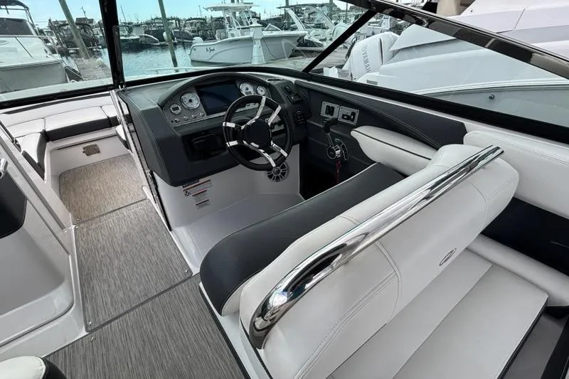 Slide: The Image of Interior of a 2015 Regal 2800 Bowrider boat with sleek dashboard and seating. - 8