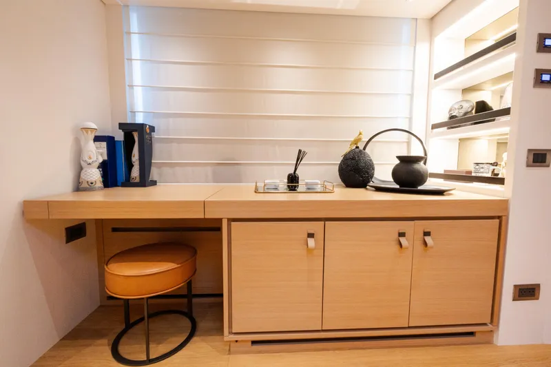 Slide: The Image of Modern interior of Sanlorenzo SL96 yacht, featuring elegant wooden cabinetry and decorative accents. - 16