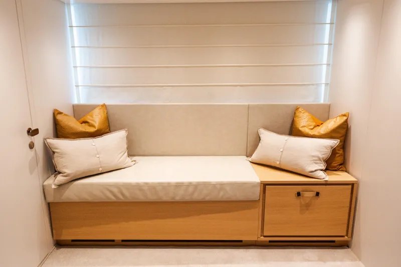 Slide: The Image of Luxurious seating area on 2021 Sanlorenzo SL96 yacht with cushions and wooden storage. - 21