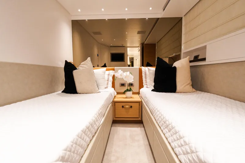 Slide: The Image of Luxurious twin cabin interior on 2021 Sanlorenzo SL96 yacht, featuring elegant decor and ambient lighting. - 26